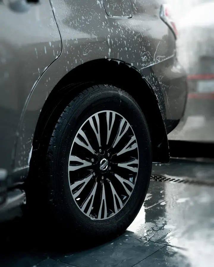 A clean alloy wheel and tyre with water droplets
